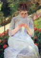Young woman sewing in the garden