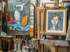 A typical artist's studio, with paintings and supplies