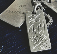 A metal dog tag most likely engraved using a laser 