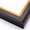This steep-edged, stepped crown moulding frame features a matte antique black finish delineated by a thin red outer corner.  The inside lip contrasts with a bold gold foil. The unique 1.5 " outside depth gives this frame a deep, majestic appearance.

2.125 " width: ideal for medium and large images. Give a family photo a royal air, or border an elegant oil painting or print with this frame.