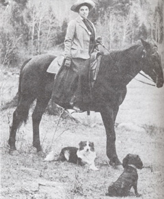 Canadian artist Emily Carr on horseback with her dogs