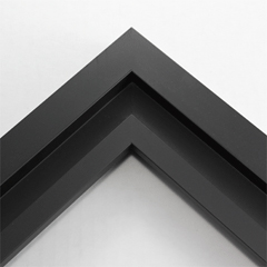 This simplistic yet modular matte black frame is designed for metal prints, acrylic prints and dry mounts. This smart design features a minimalist stepped profile that serves as a floater frame or a standard picture frame.

For the floating effect, the print can be attached on top of the inner step of the frame, without sacrificing the artwork edges.

This frame can also be used as standard picture frame. The lowered center paired with slightly raised outer lip creates a frame within a frame effect. However, due to the inner most lip of the frame, a fraction of the artwork will be hidden. But, this can be avoided with a linen liner combo.