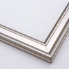 This narrow frame features a crown moulding profile finished in silver leaf. An antique look is achieved with a gentle brushed effect that highlights the corners of the bevelled edges.
1.25 " width: ideal for small- to medium-size images. Border a black-dominant grayscale photograph or acrylic painting with this stylishly simple frame.