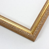This antique solid wooden gold frame featuring an intricate design and overlaid with elegant beaded lip pattern.