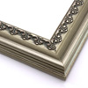 This solid wood frame features a crown moulding profile in a bold, bronze-brushed silver. The slight distressing on the deeply scooped face and the faint red patina on the delicate inner design give it an antique look that suits old paintings, prints and family photographs alike.
2.5 " width and 1 " high at outer edge: ideal for medium- to large-size images.