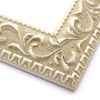 A large, reverse curve profile frame with an intricate leaf design bordered by a geometric outer edge and beaded inner lip. The cream-colour base features a white patina for added depth on the topmost points of the design. Strong, solid wood construction.
2.75 " width: ideal for large and extra large images.